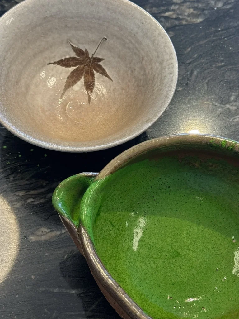 Matcha tea bowls on a dark countertop